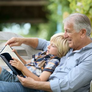 Grandpa reading to grandson